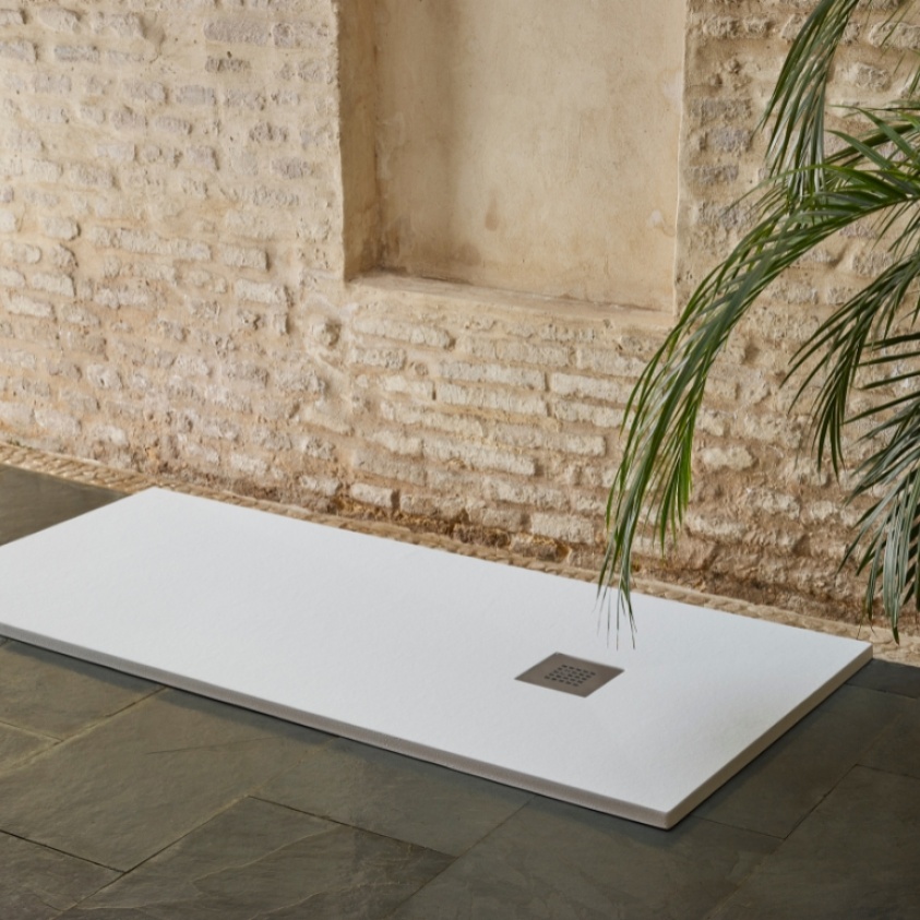 Product Lifestyle image of the Sommer Essenza White Slate 900mm x 900mm Shower Tray in a room with brick walls